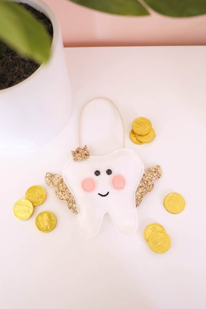 tooth fairy pillow surrounded by chocolate gold coins