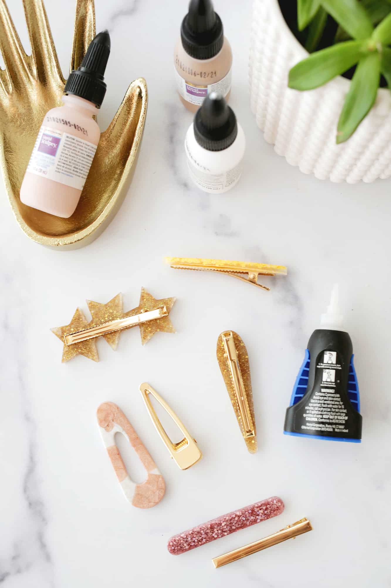 various barrette tops and barrette backings being glued together