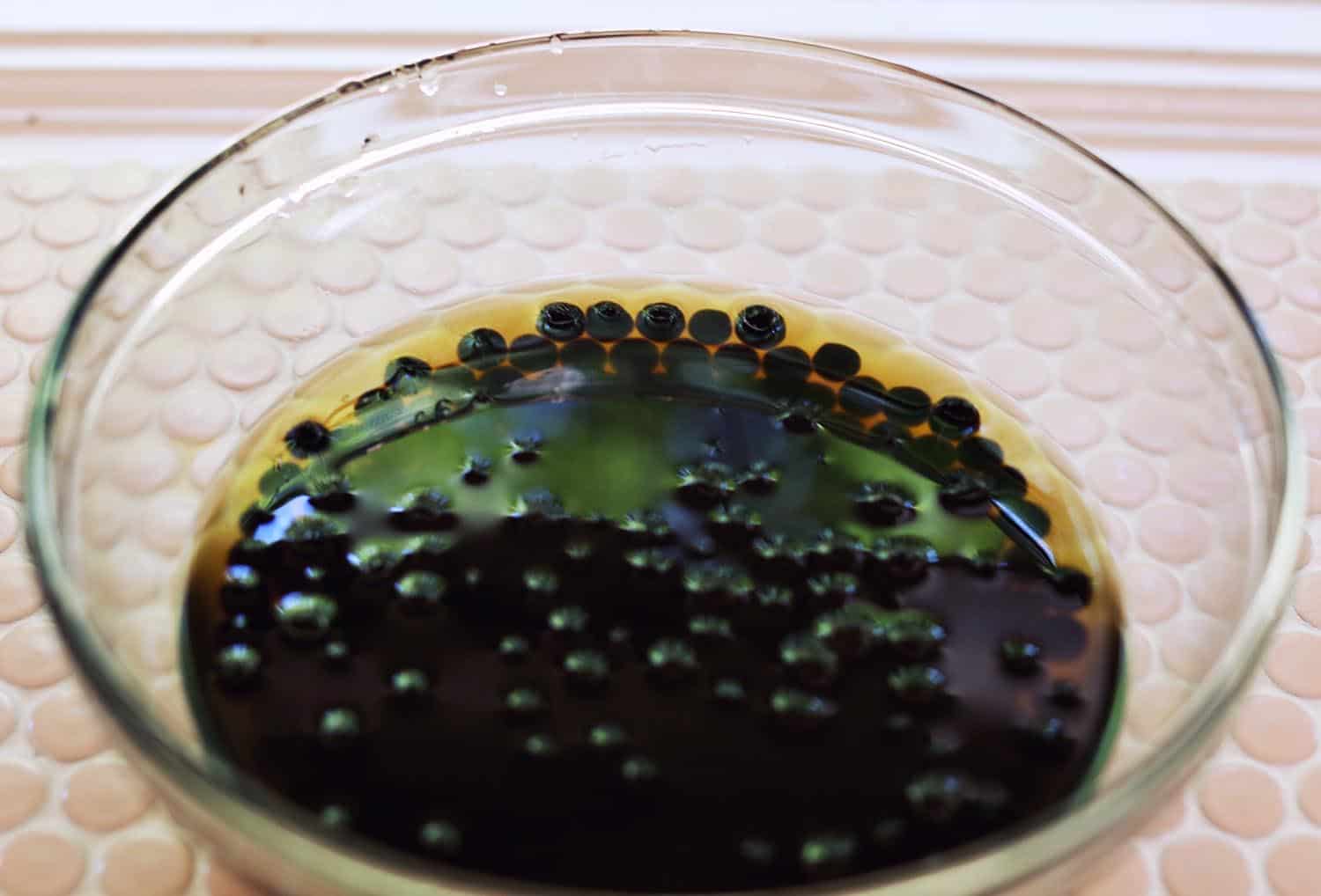 glass mixing bowl with boba pearls in water