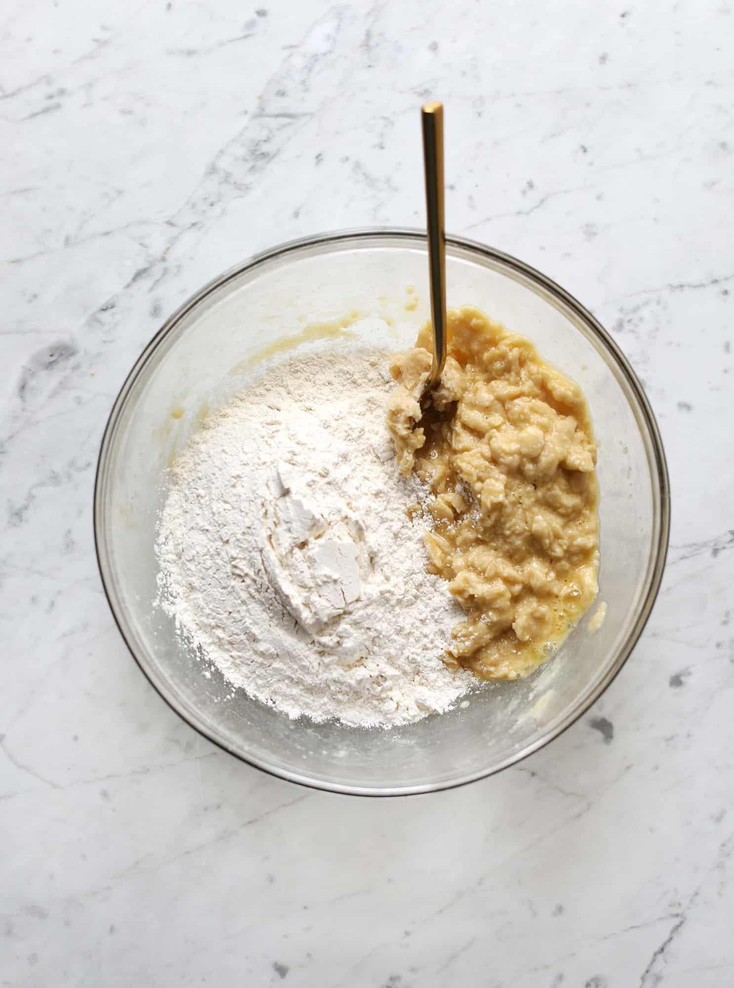 ingredients in a glass mixing box with a spoon sticking out
